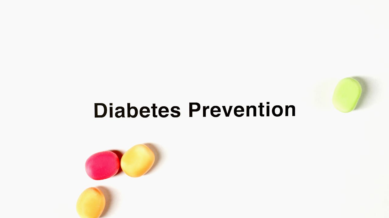 A diabetes prevention message on a white background with colorful sweets symbolizing unhealthy choices.