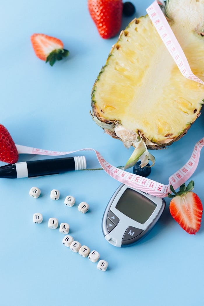 A medical concept with fruits, glucometer, and stop diabetes message on blue background.